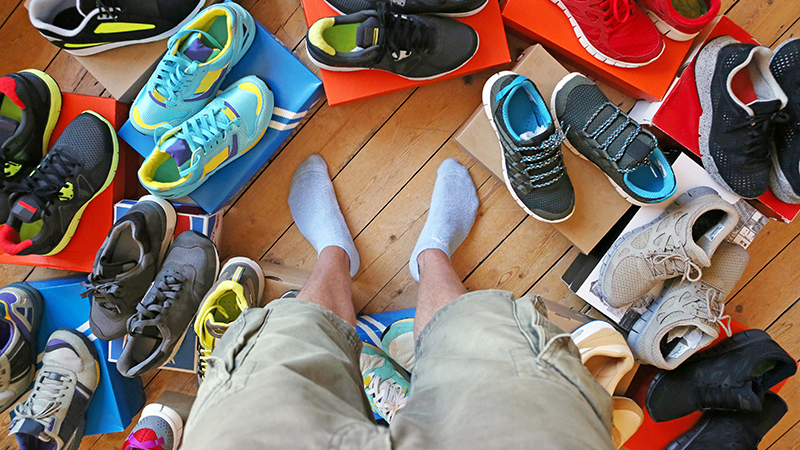 Various running shoes spread out on the floor.