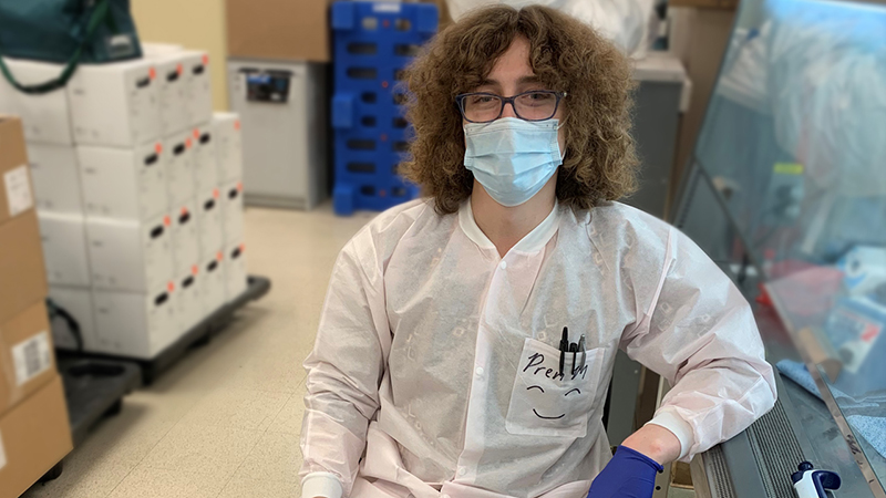 Northwestern Medicine Molecular Pathology Technologist Pren Morley seated in lab with a lab coat